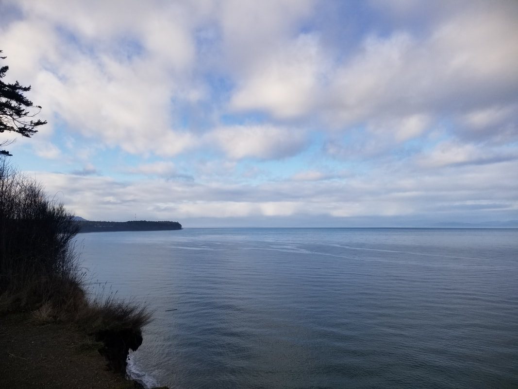 Clouds and open water filling a wide view of the ocean