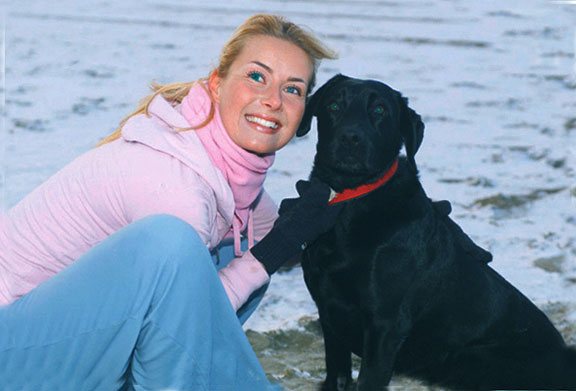 Restored color portrait of a woman with a black dog